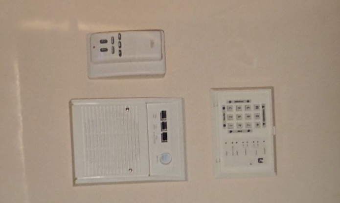 a newly-installed trio of wall-mounted security and thermostat devices