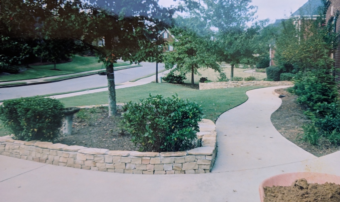 triangular flower and tree beds enclosed in 3 foot high rounded stones