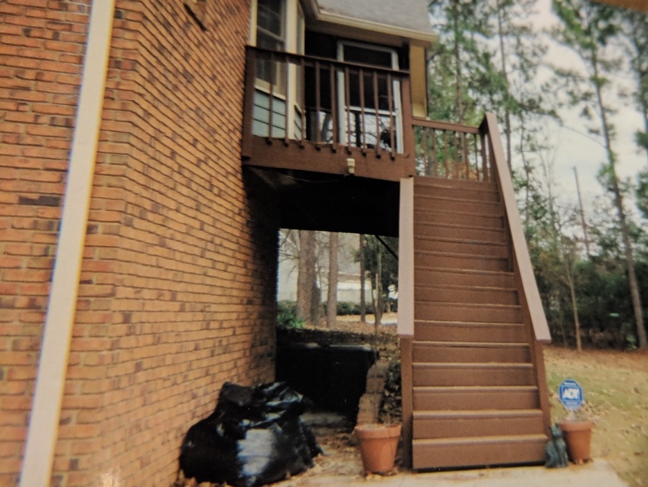 backdoor porch on second floor with accompanying staircase 