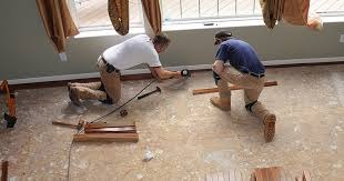 two construction associates putting down a hardwood floor